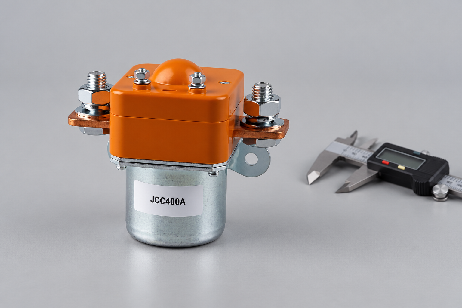 JCC400A unpowered DC contactor beside a separate caliper on an inspection bench